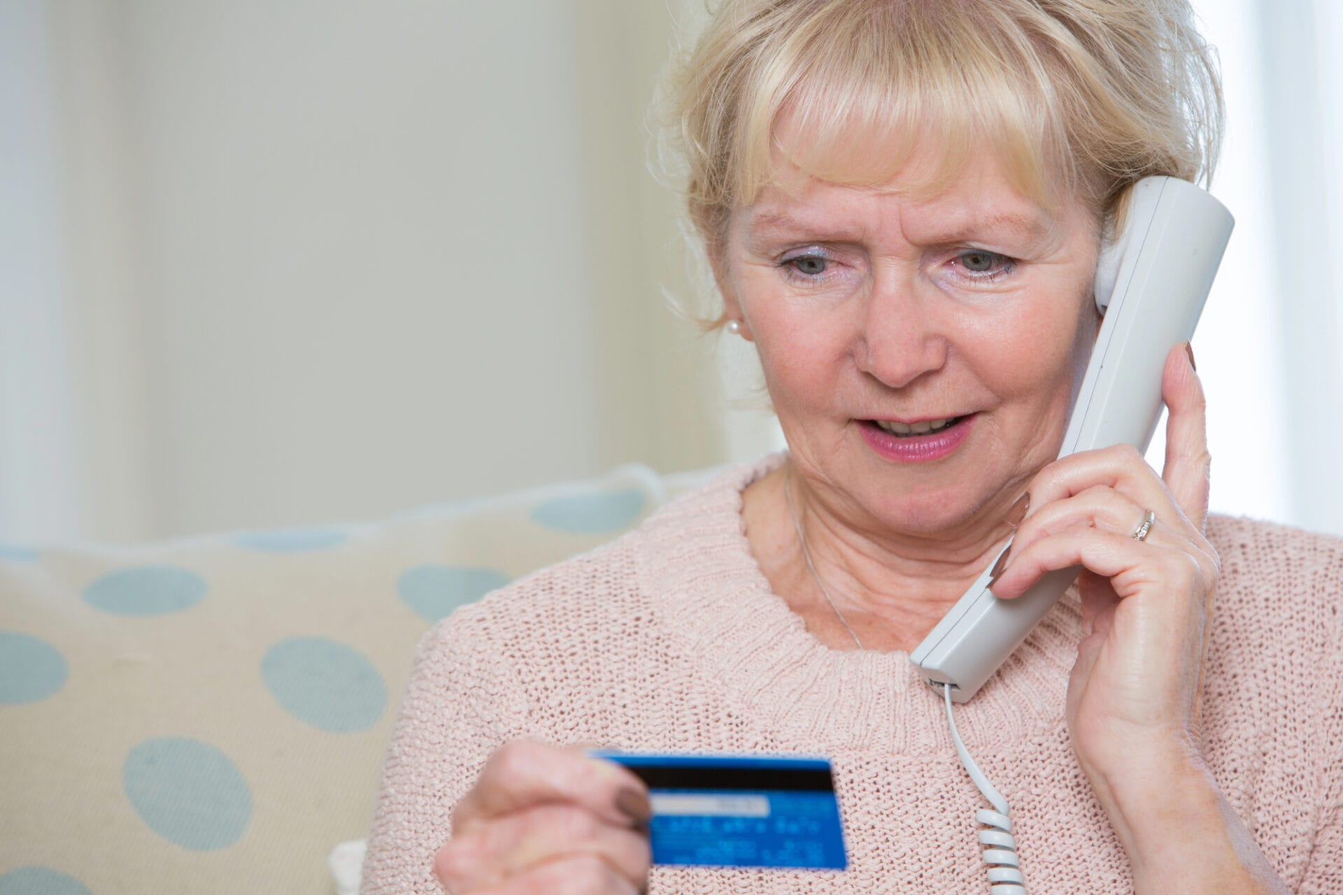 Woman on phone with credit card